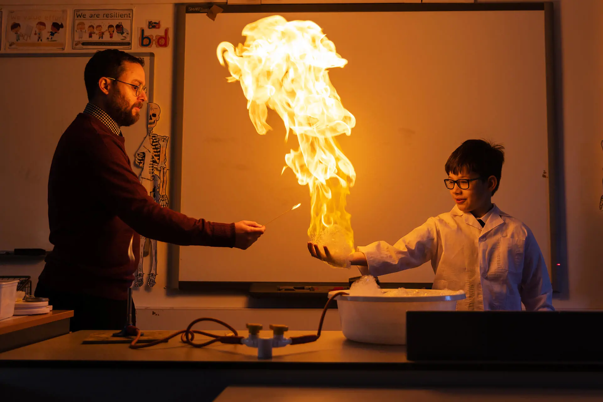 A Prep School pupil conducting a science experiment with his teacher at The Ryleys School, a private school in Cheshire.