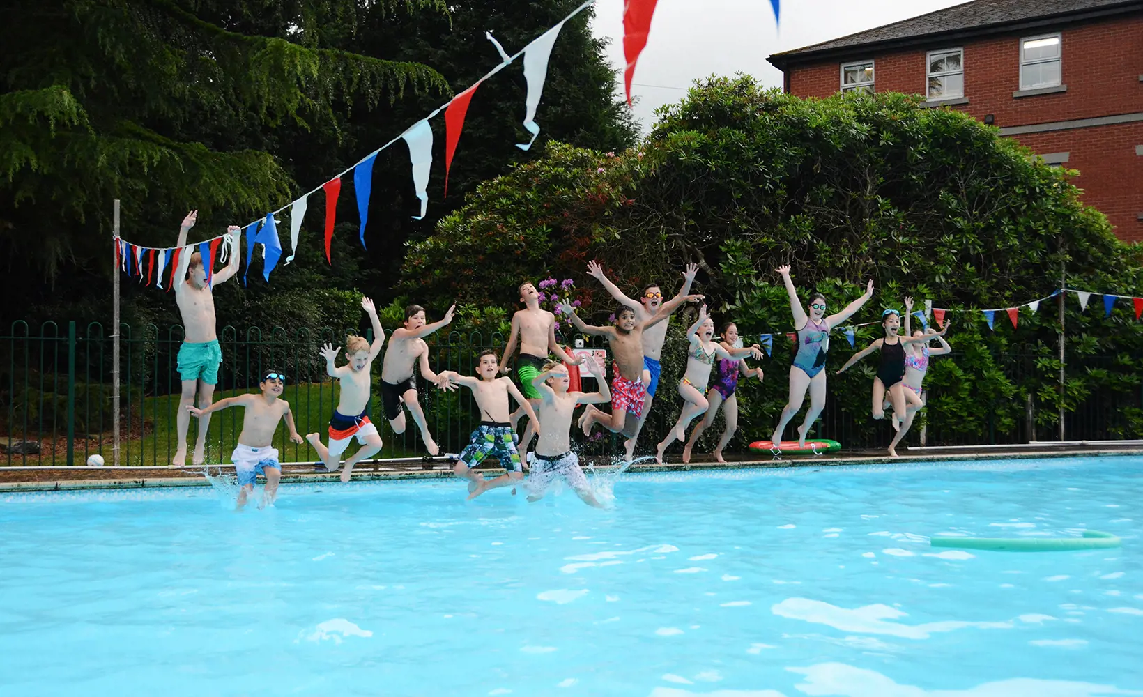 Students at The Ryleys School, Cheshire, jumping into the swimming pool