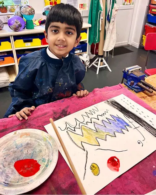 A pupil at The Ryleys School, a private school in Cheshire, showing their Kandinsky-inspired artwork