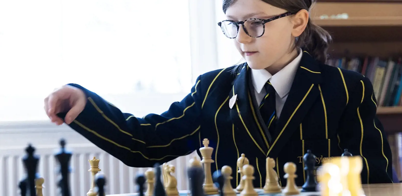 Prep School pupil playing chess at The Ryleys School, a private school in Cheshire